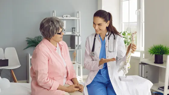 A provider talks with a patient during a consultation.