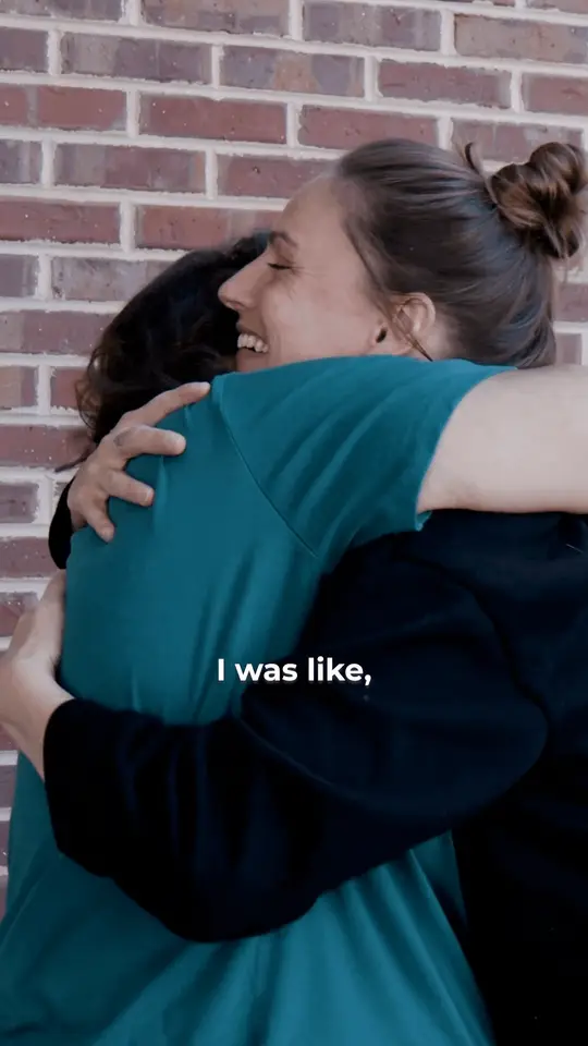 Patient story clip: two women share a long hug. The burned-in caption begins: I was like,